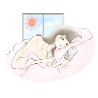 朝起きてベッドでスマホをチェックする人