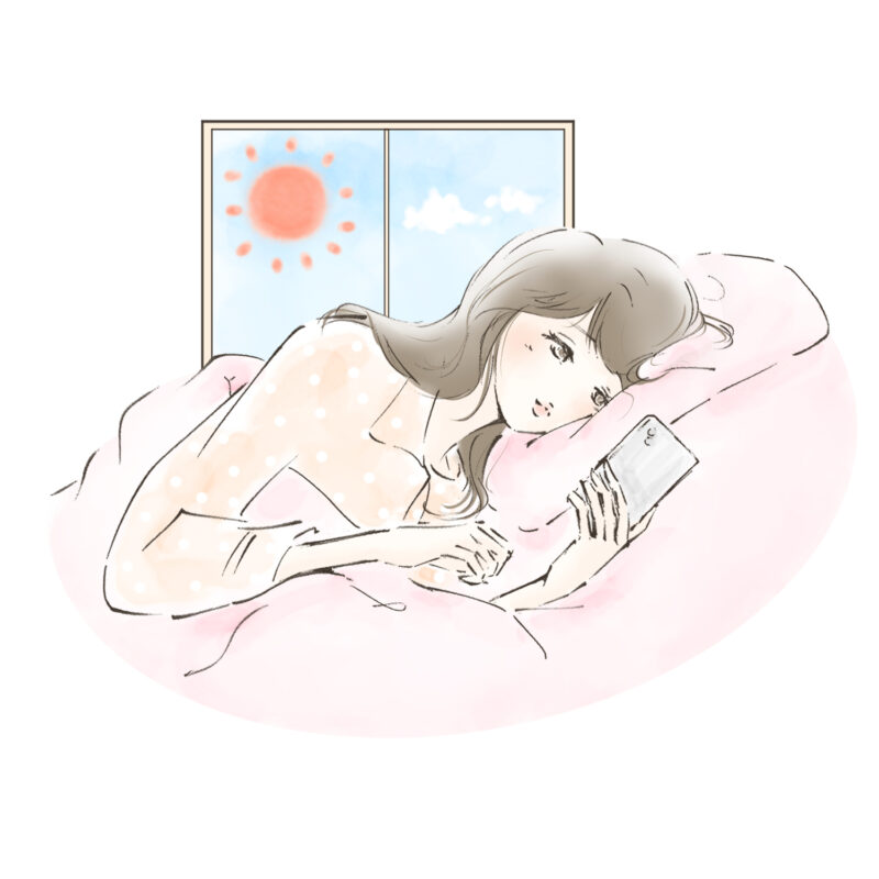 朝起きてベッドでスマホをチェックする人